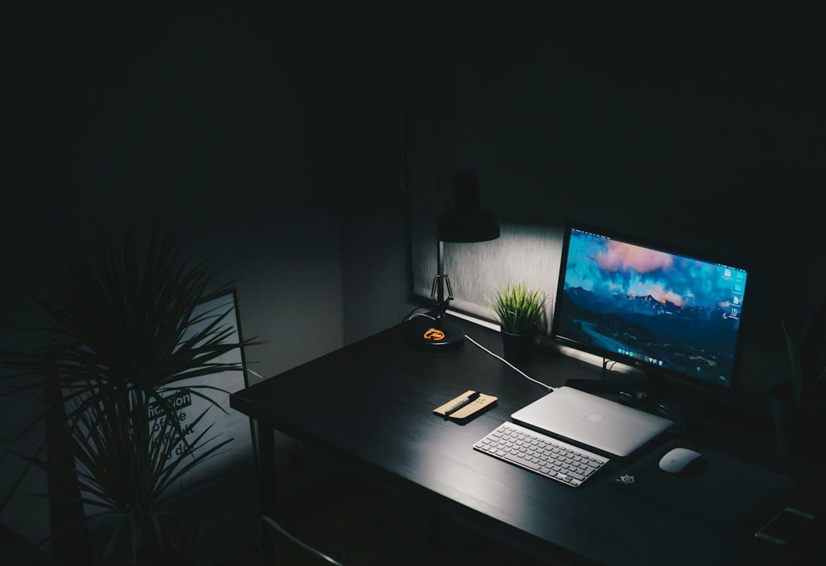 A quiet desk with a monitor at night